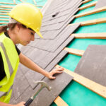 Woman working on a roof