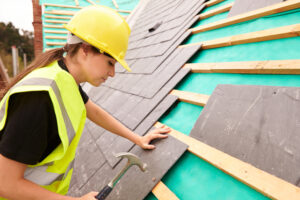 Woman working on a roof