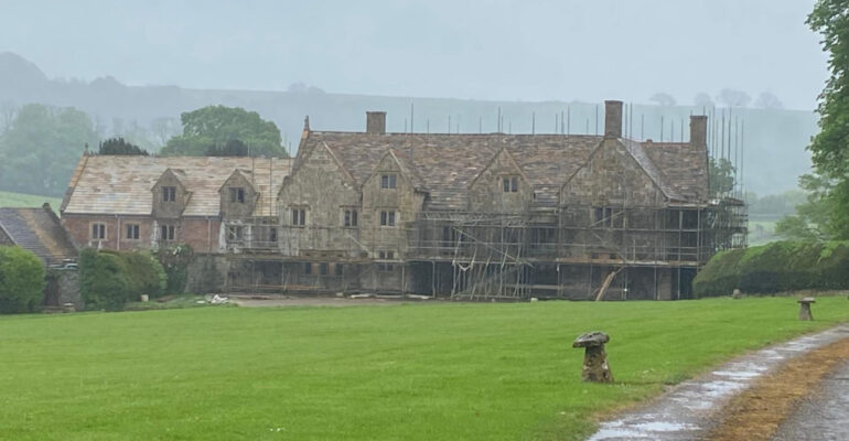 Home with scaffolding for roof repair work